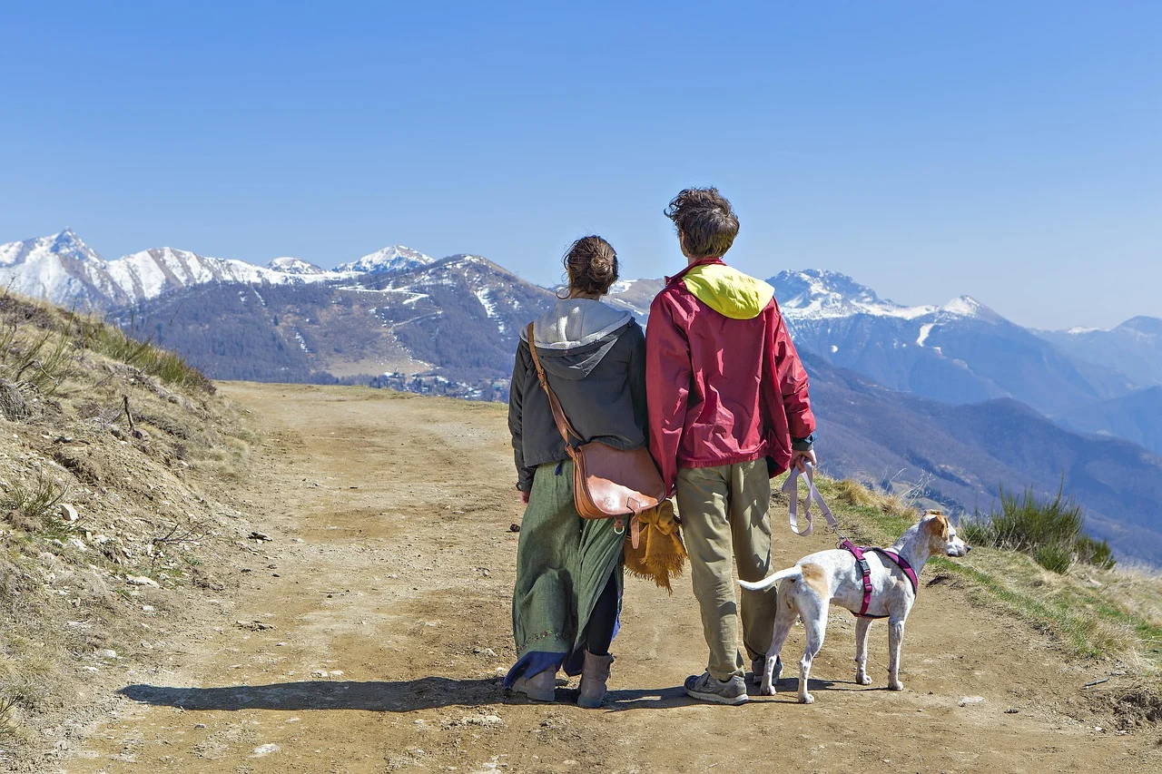 Couple enjoying a scenic trip outdoors with their dog