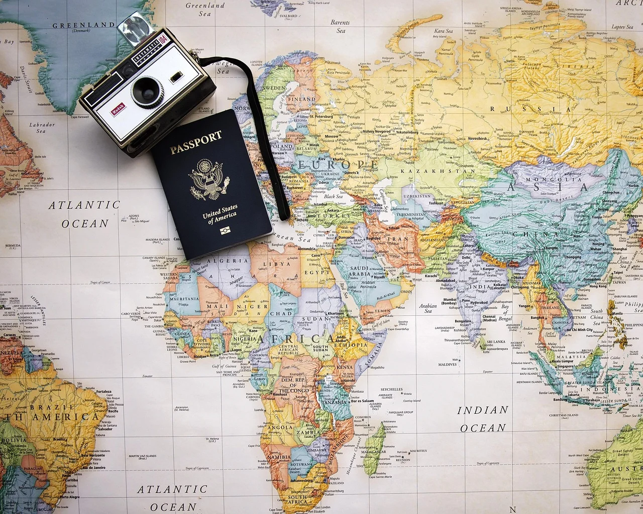 Travel essentials with map, camera, and passport symbolizing global destinations