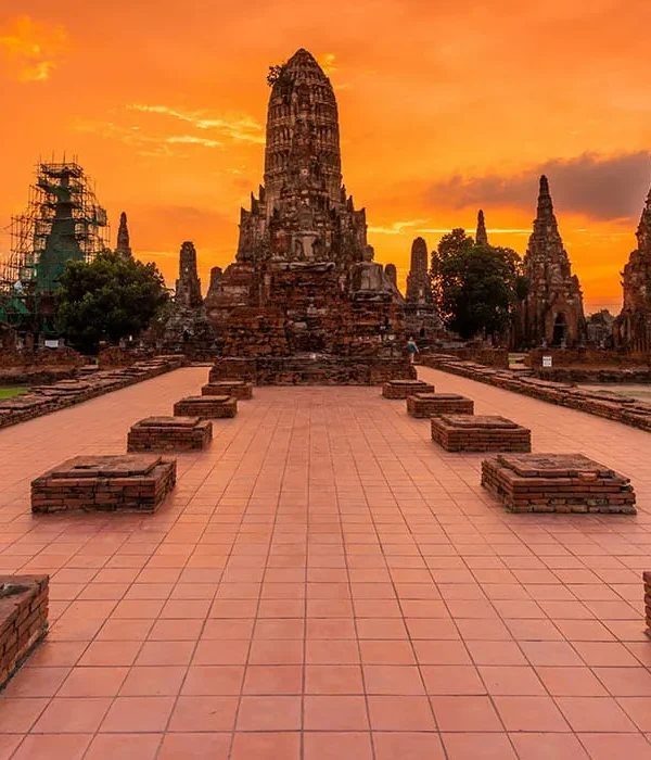 Tourist couple sitting and enjoying the scenic view of ancient temples in Ayutthaya