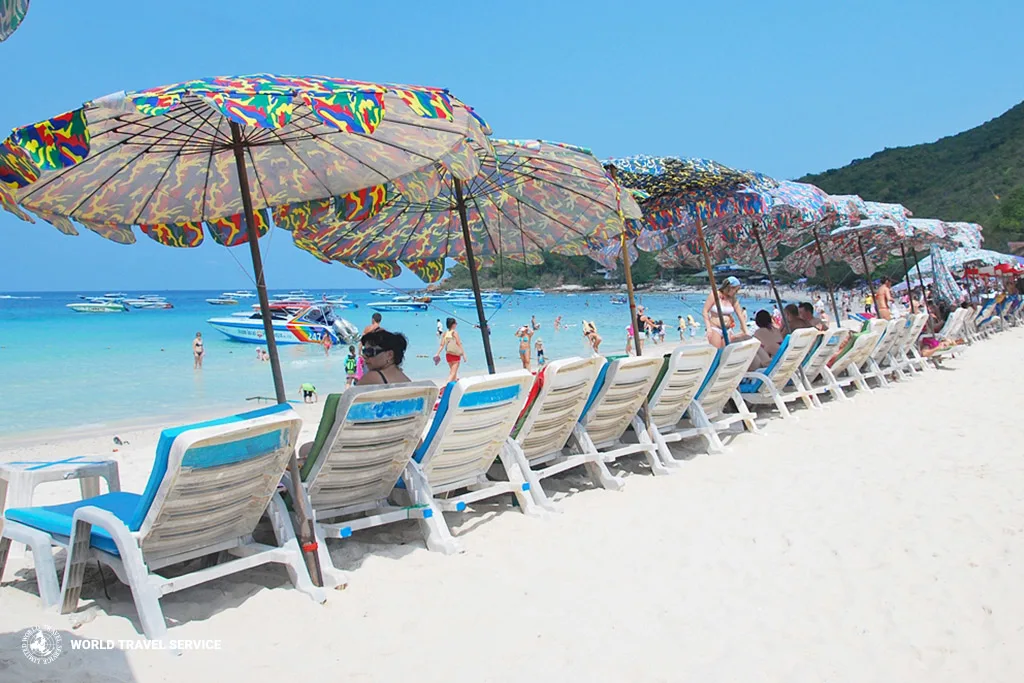 ourists relaxing under umbrellas and enjoying beach views at Coral Island (Koh Larn)