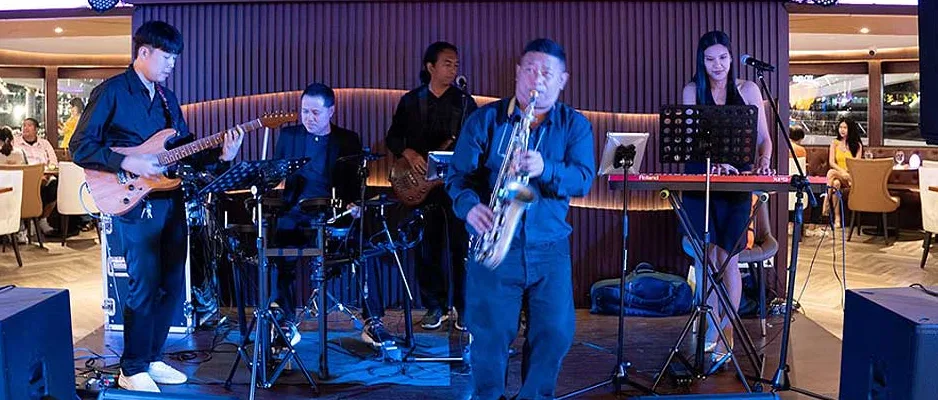 Musicians performing live music aboard The Opulence Luxury Cruise in Bangkok