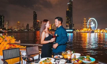 Couple enjoying sunset from the 3rd deck of Opulence Cruise in Bangkok
