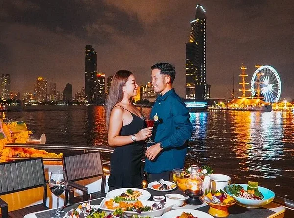 Couple enjoying sunset from the 3rd deck of Opulence Cruise in Bangkok