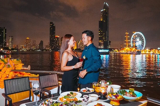 Couple enjoying sunset from the 3rd deck of Opulence Cruise in Bangkok