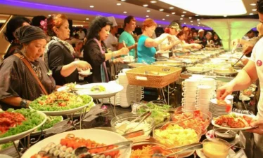 Guests enjoying buffet dinner inside Chao Phraya Princess Cruise in Bangkok
