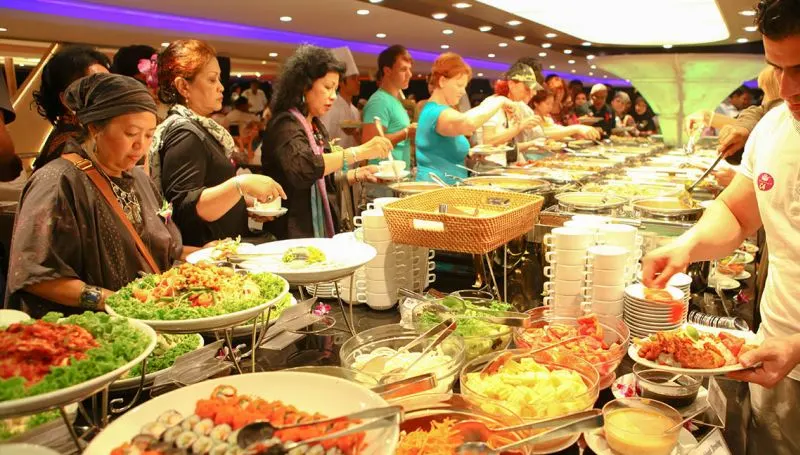 Guests enjoying buffet dinner inside Chao Phraya Princess Cruise in Bangkok