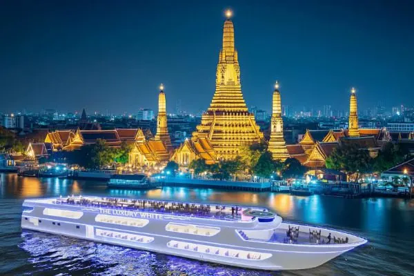 Chao Phraya Dinner Cruise at night with illuminated Wat Arun in the background