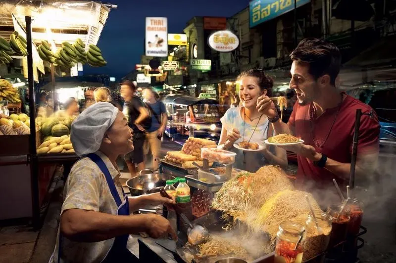 Authentic Thai meal including Tom Yum soup, Pad Thai, and mango sticky rice