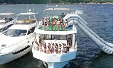 Distant view of Big Daddy yacht party in Pattaya with people enjoying on deck in the sea