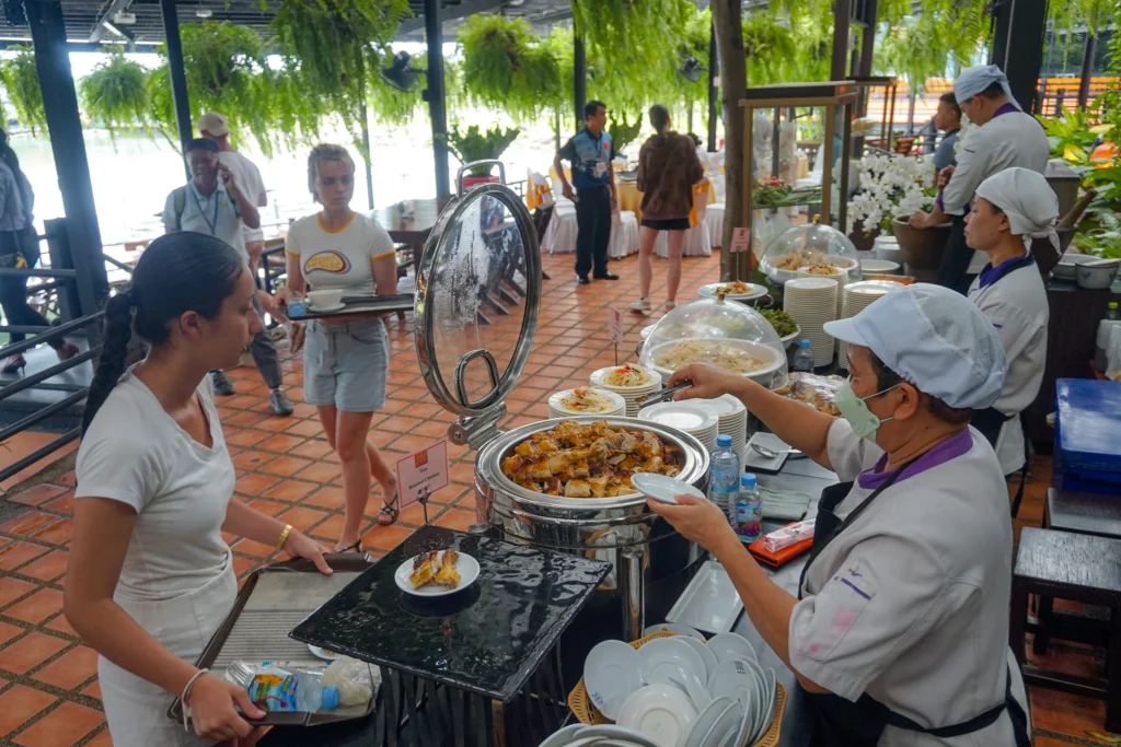 Buffet lunch setup at Nong Nooch Garden restaurant with Thai dishes