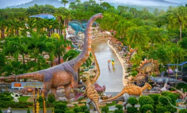 Aerial view of Nong Nooch Tropical Garden with dinosaur statues and walking tourists