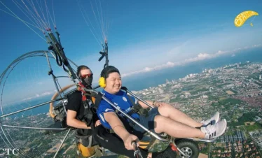 Paramotor flying over the coastline of Pattaya during sunrise