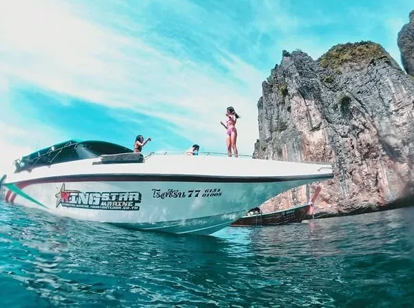Tourists boarding speedboat for Phi Phi Island adventure