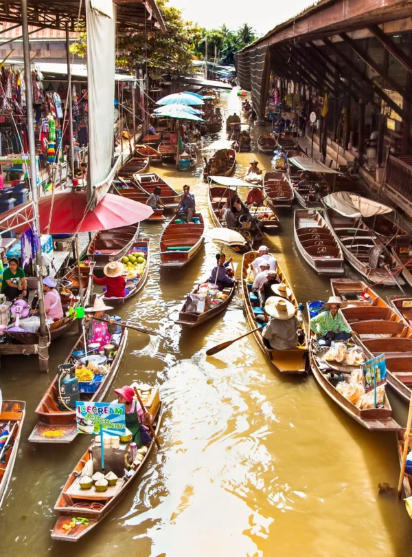 Vibrant boats filled with tropical fruits and local food at Damnoen Saduak Floating Market