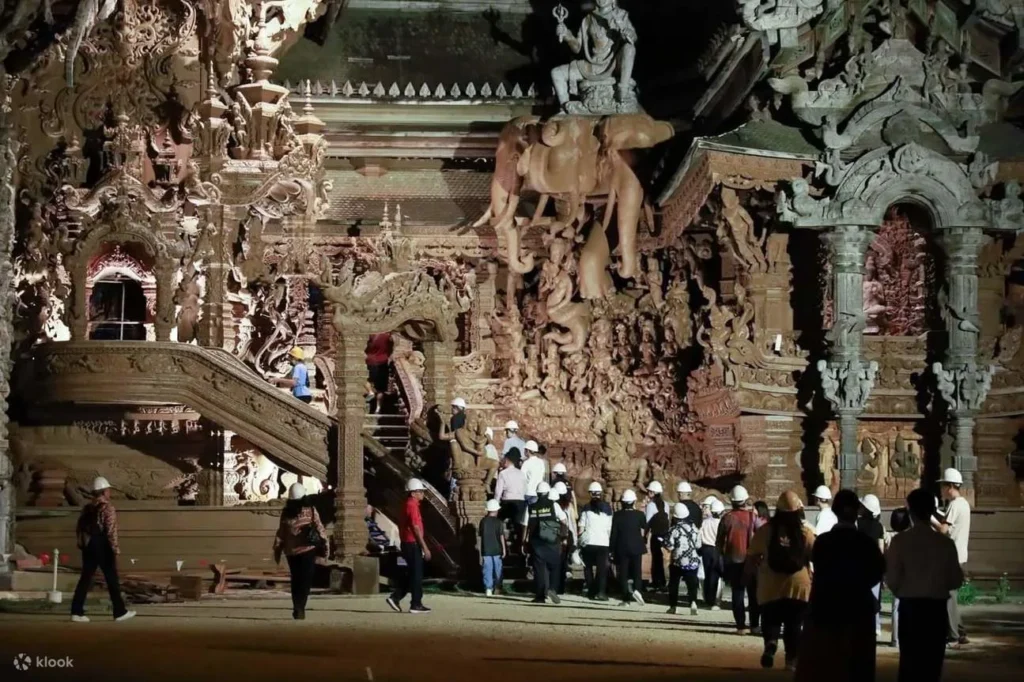 Tourist exploring the wooden sculptures at The Sanctuary of Truth
