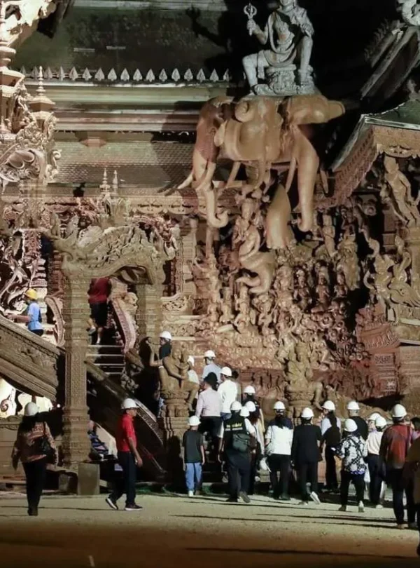 Tourist exploring the wooden sculptures at The Sanctuary of Truth