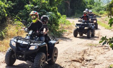 Group of tourists riding ATVs through off-road trails in Pattaya