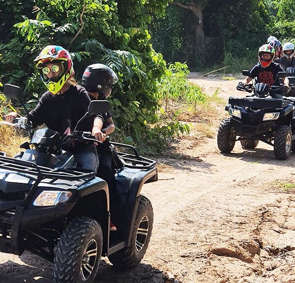 Group of tourists riding ATVs through off-road trails in Pattaya