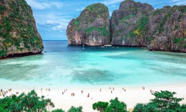 Tourists exploring Phi Phi Islands by speedboat in crystal-clear waters