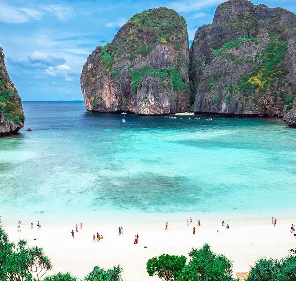 Tourists exploring Phi Phi Islands by speedboat in crystal-clear waters