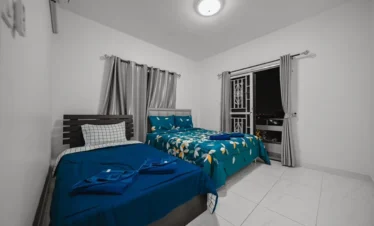 Air‑conditioned bedroom with king and queen beds