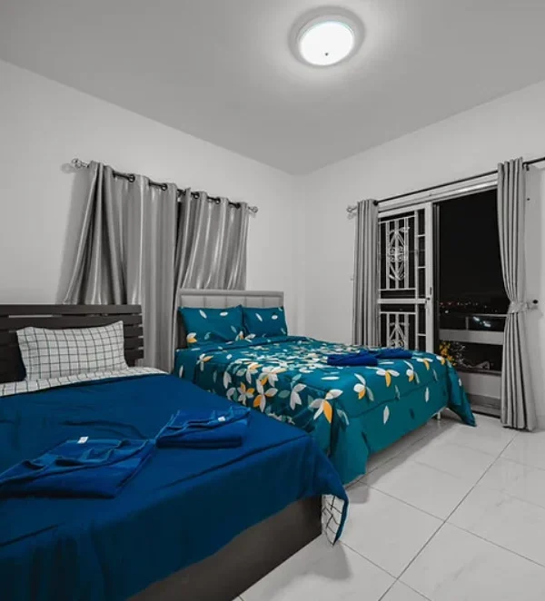 Air‑conditioned bedroom with king and queen beds