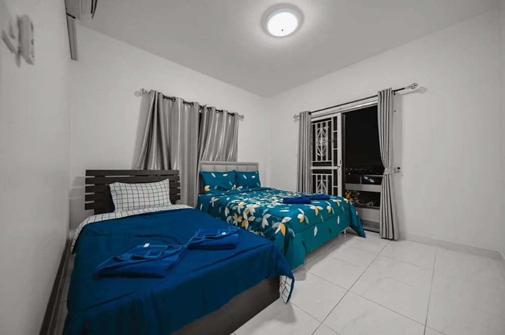 Air‑conditioned bedroom with king and queen beds
