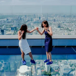 Visitors enjoying the thrilling glass tray experience at Mahanakhon Skywalk