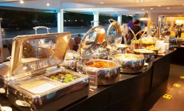 Thai and international buffet dinner setup on The Planet Cruise