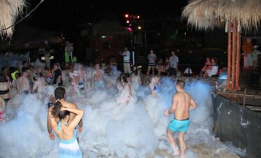 People dancing and enjoying foam party experience at H2O Pool Pattaya