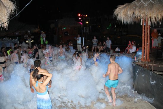 People dancing and enjoying foam party experience at H2O Pool Pattaya