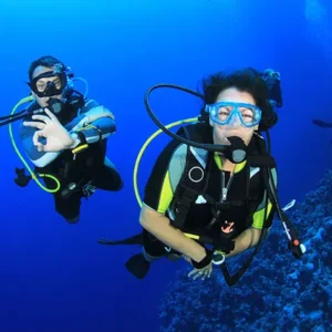 Beginner diver underwater in Pattaya during try scuba experience with instructor