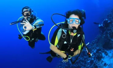 Beginner diver underwater in Pattaya during try scuba experience with instructor