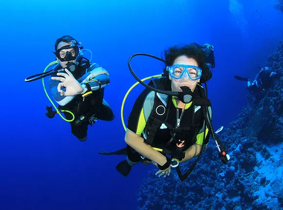 Beginner diver underwater in Pattaya during try scuba experience with instructor