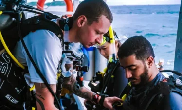 Scuba instructor briefing first-time divers on boat before diving in Pattaya