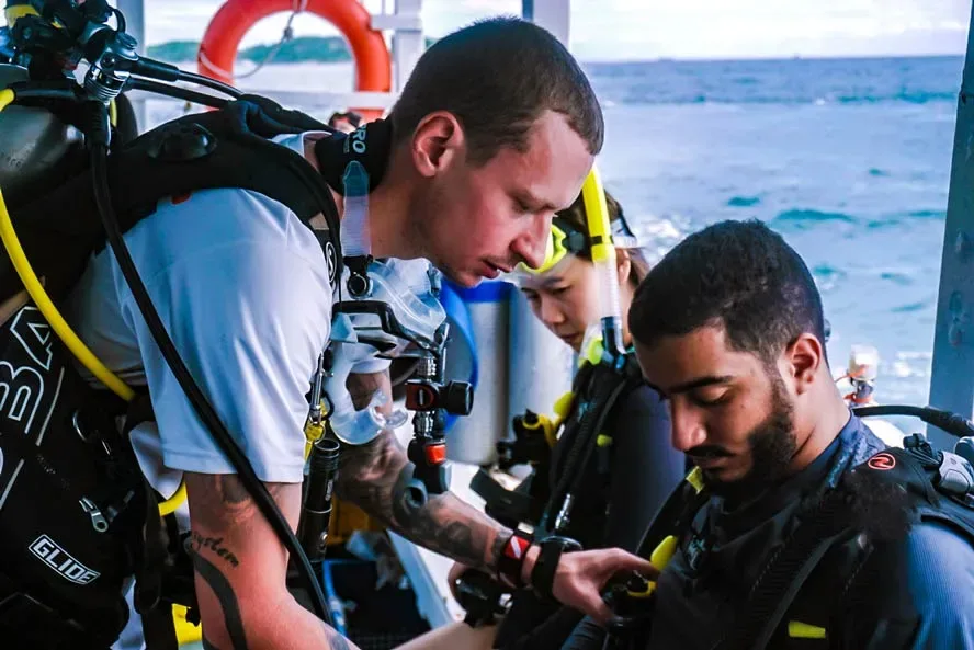 Scuba instructor briefing first-time divers on boat before diving in Pattaya