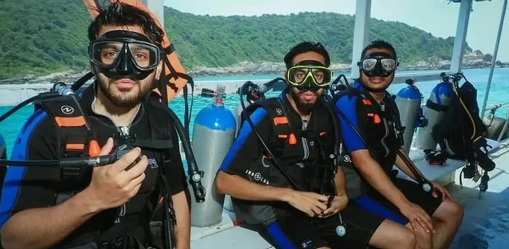 Beginner diver underwater in Pattaya during try scuba experience with instructor