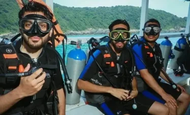 Beginner diver underwater in Pattaya during try scuba experience with instructor