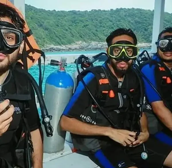 Beginner diver underwater in Pattaya during try scuba experience with instructor
