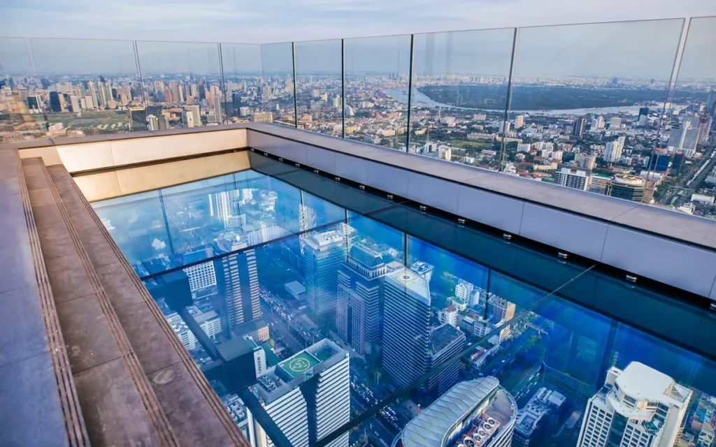 Tourist walking over the glass tray at the Mahanakhon Skywalk, 314 meters above ground