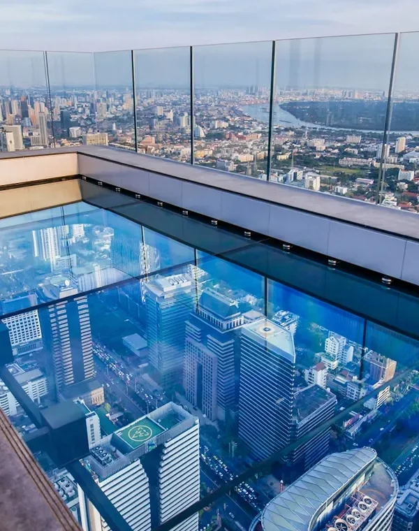 Tourist walking over the glass tray at the Mahanakhon Skywalk, 314 meters above ground
