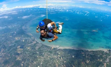 Skydiver freefalling over Pattaya coastline from 14,000 feet in Thailand