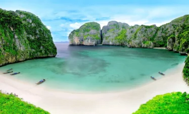 Aerial view of the turquoise waters and limestone cliffs of the Phi Phi Islands in Thailand.