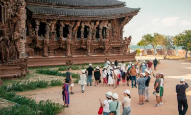 Visitors exploring the Sanctuary of Truth Pattaya with guided tour
