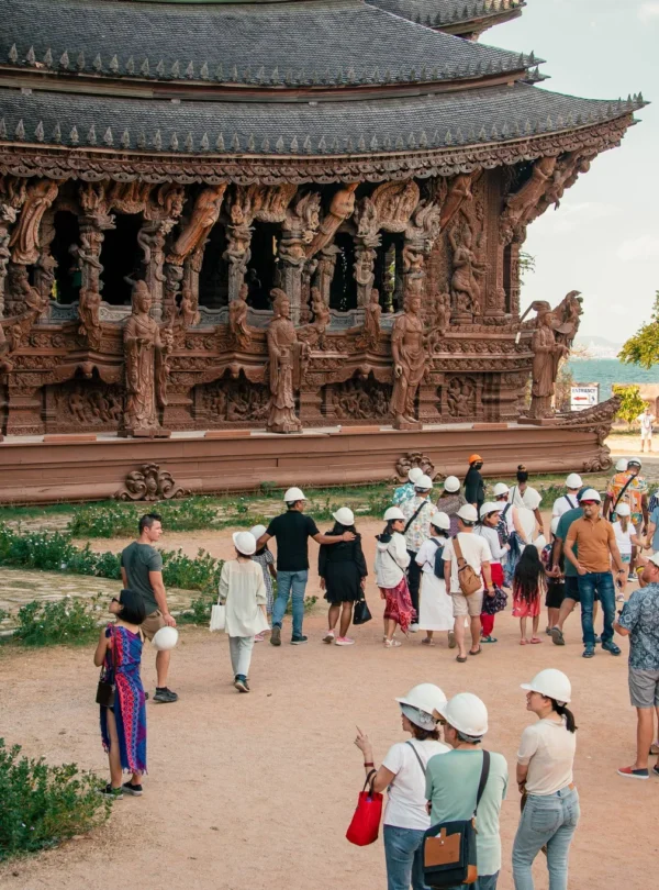 Visitors exploring the Sanctuary of Truth Pattaya with guided tour