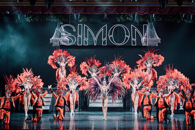 Performers on stage during the Simon Cabaret Show in Phuket with colorful costumes and lighting effects.